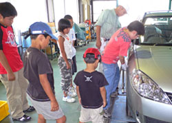 自動車タイヤの交換作業に取り組む子どもたち