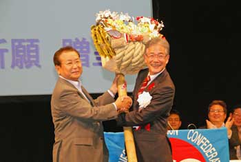 川口連合大阪会長（左）から必勝祈願の熊手を受け取る平松市長